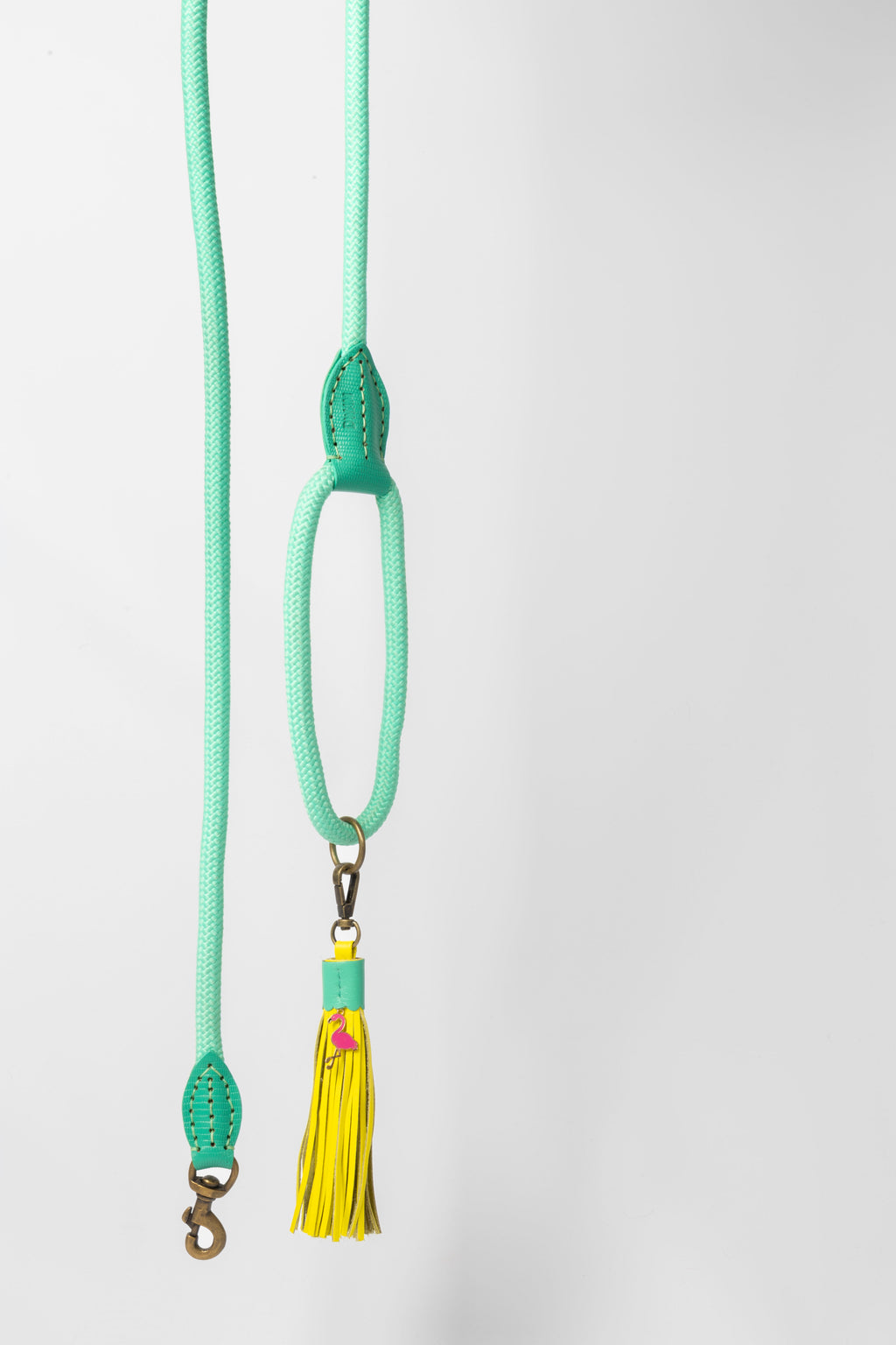 Light green lanyard with a yellow tassel on a white background