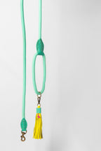 Light green lanyard with a yellow tassel on a white background