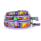 Colorful dog collar with geometric patterns and tassels on a white background