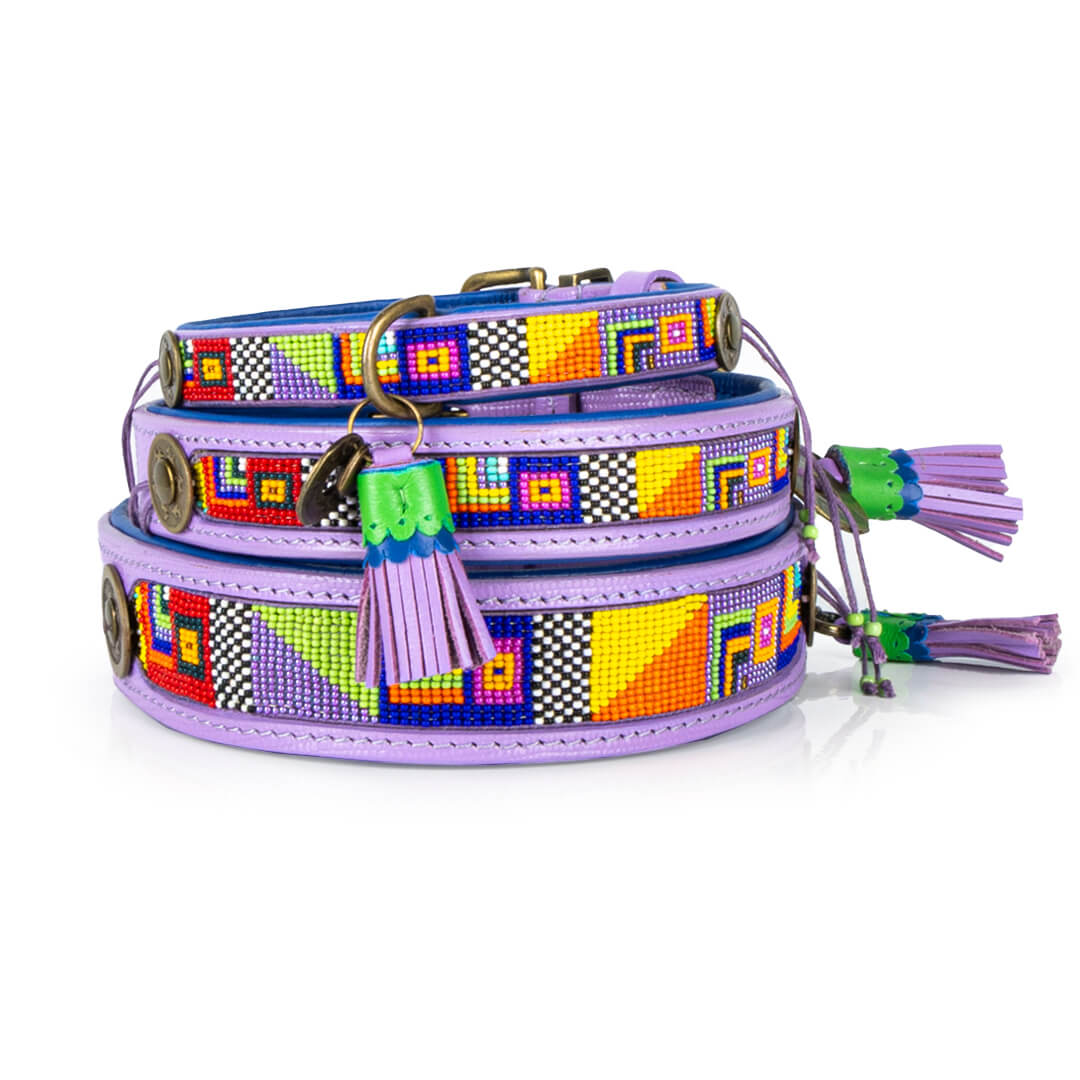 Colorful dog collar with geometric patterns and tassels on a white background