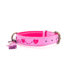 Pink dog collar with heart designs and a tassel on a white background