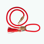 Red dog leash with leopard print clasp and tassel on a white background
