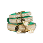 Two decorative dog collars with pearls and gold hardware on a white background