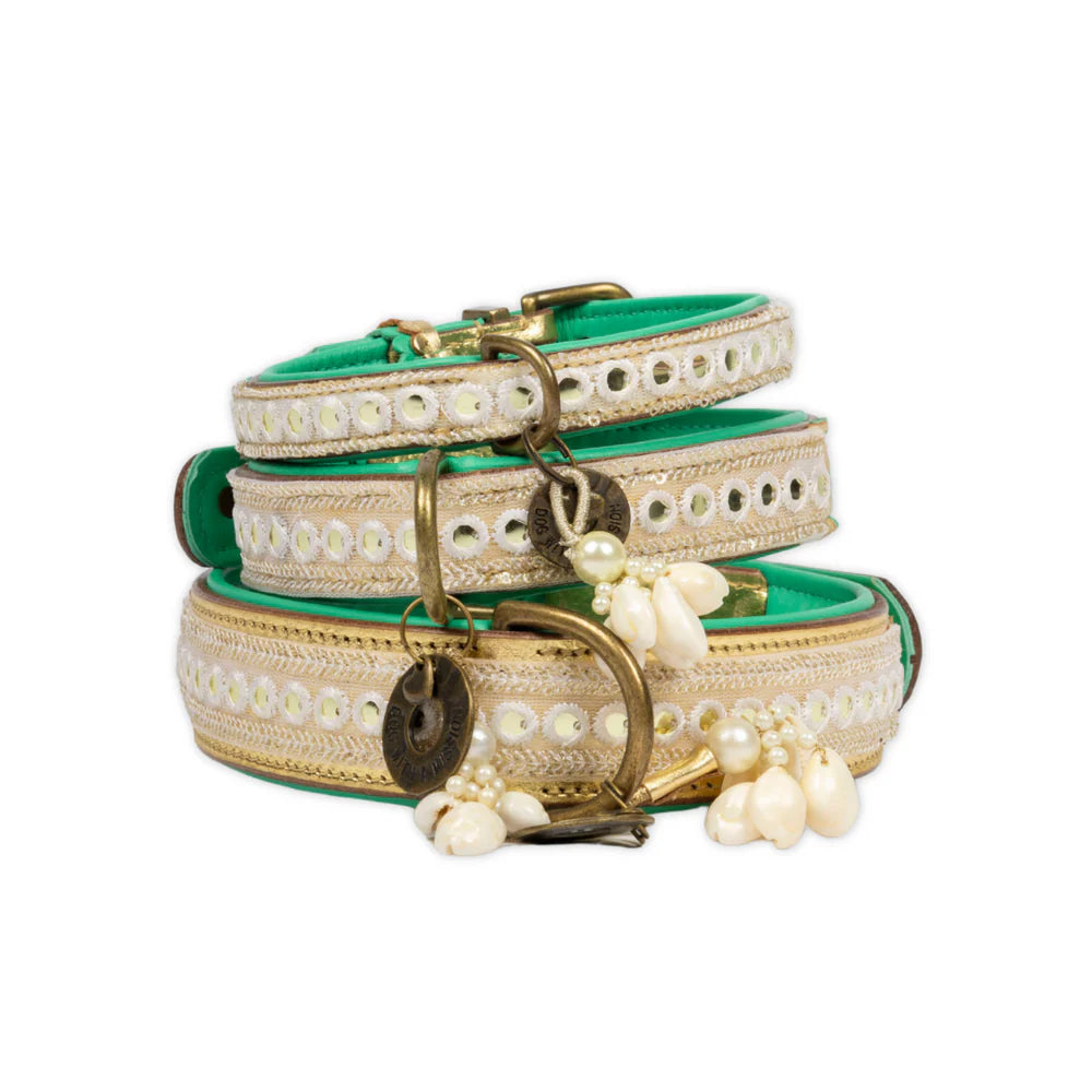 Two decorative dog collars with pearls and gold hardware on a white background