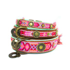 Colorful dog collar with decorative elements on a white background